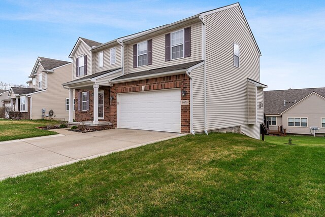 8079 Wildwood Ln, White Lake, MI 48386 - view of front of home with an attached garage, concrete driveway, a front yard, and brick siding