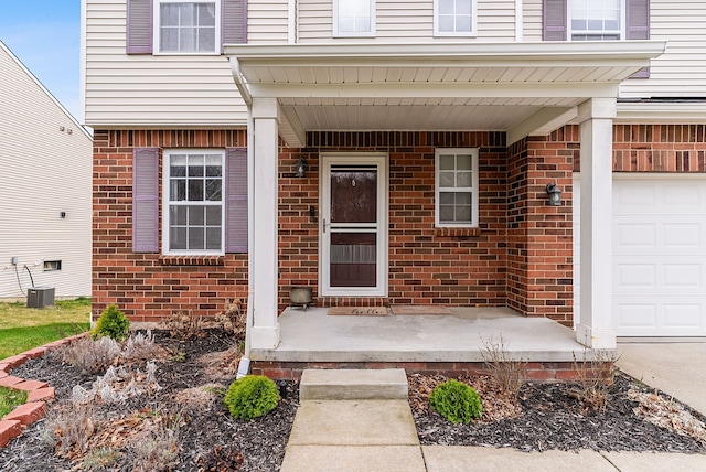 8079 Wildwood Ln, White Lake, MI 48386 - doorway to property with brick siding, a garage, covered porch, and central AC unit