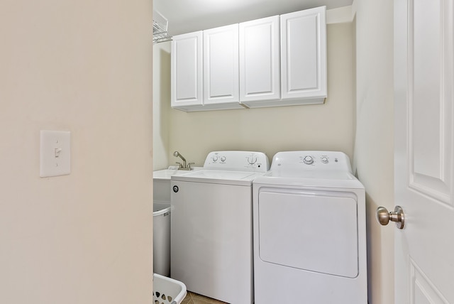 8079 Wildwood Ln, White Lake, MI 48386 - laundry room featuring separate washer and dryer and cabinet space
