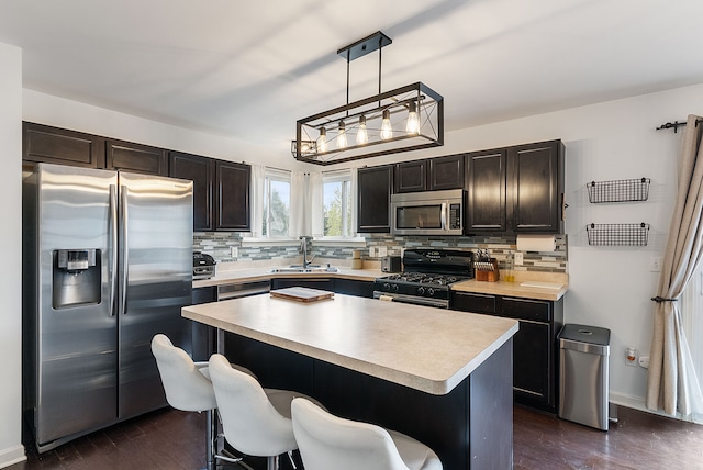 8079 Wildwood Ln, White Lake, MI 48386 - kitchen with appliances with stainless steel finishes, a sink, backsplash, and light countertops