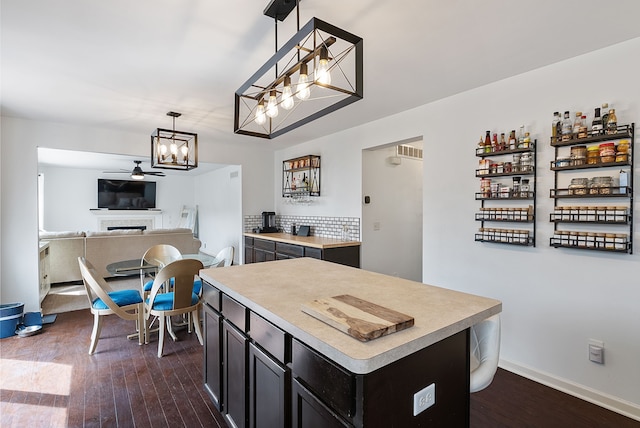 8079 Wildwood Ln, White Lake, MI 48386 - kitchen with a chandelier, dark wood-style flooring, light countertops, and hanging light fixtures