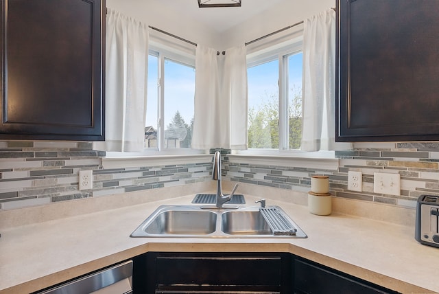 8079 Wildwood Ln, White Lake, MI 48386 - kitchen with a sink, light countertops, tasteful backsplash, stainless steel dishwasher, and dark brown cabinetry