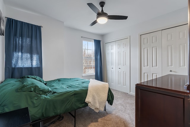 8079 Wildwood Ln, White Lake, MI 48386 - bedroom with carpet flooring, two closets, ceiling fan, and baseboards