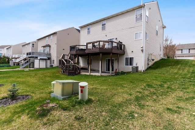 8079 Wildwood Ln, White Lake, MI 48386 - rear view of property featuring a deck, stairs, a lawn, and central AC unit