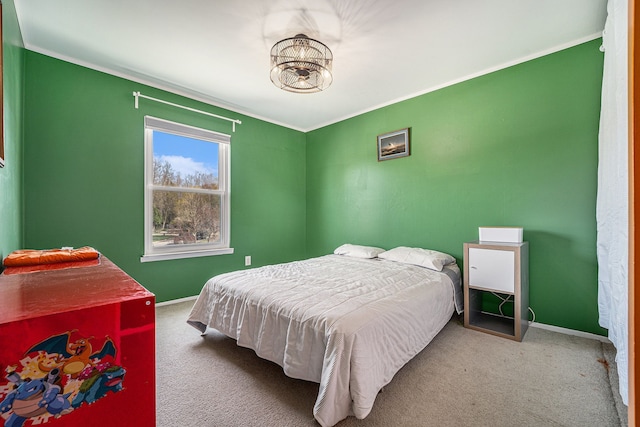 carpeted bedroom with crown molding and baseboards