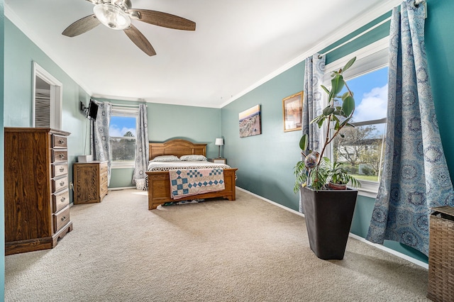 bedroom featuring ceiling fan, baseboards, ornamental molding, and carpet