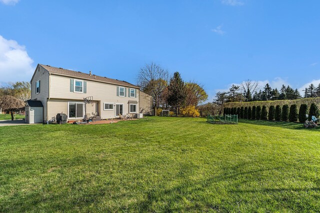 view of yard with a garage and a patio area