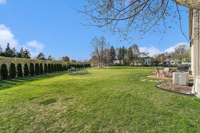 view of yard with a patio and central AC unit