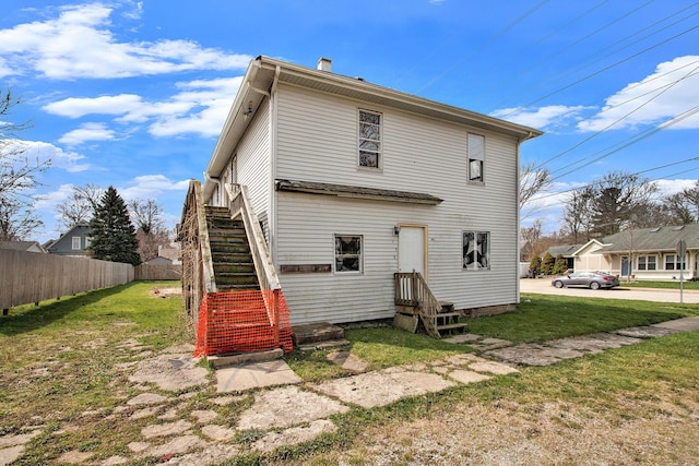 202 Poplar St, Three Oaks, MI 49128 - back of property featuring a lawn, fence, and stairs