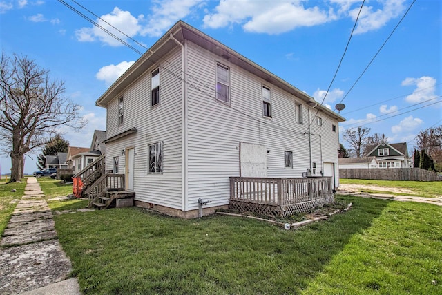202 Poplar St, Three Oaks, MI 49128 - view of side of home with fence, a lawn, driveway, and a deck