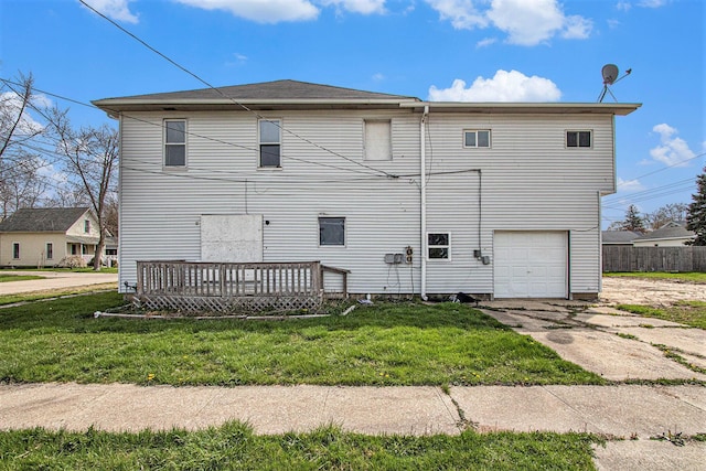 202 Poplar St, Three Oaks, MI 49128 - rear view of property with an attached garage, a wooden deck, a yard, and concrete driveway