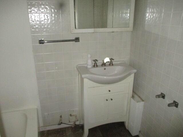 202 Poplar St, Three Oaks, MI 49128 - bathroom with a bath, tile walls, and vanity
