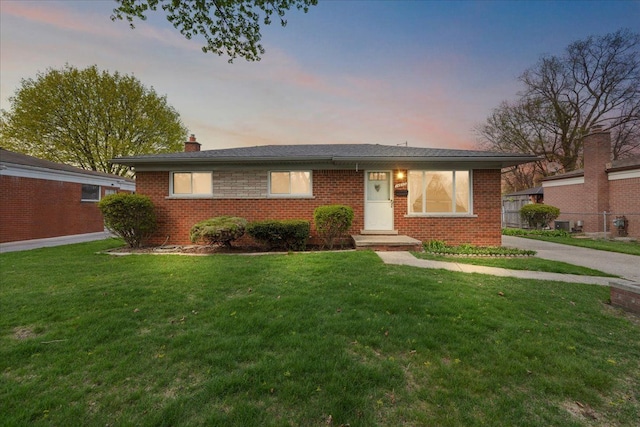 14953 Colpaert Dr, Warren, MI 48088 - view of front of property with brick siding, a front lawn, fence, and a chimney