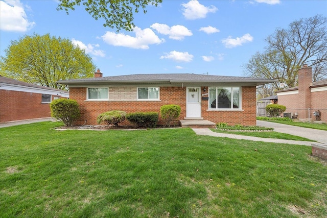 14953 Colpaert Dr, Warren, MI 48088 - ranch-style home with a chimney, a front yard, and brick siding