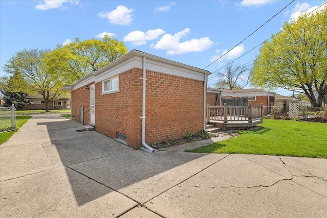 14953 Colpaert Dr, Warren, MI 48088 - view of side of property with a yard, brick siding, fence, and a wooden deck