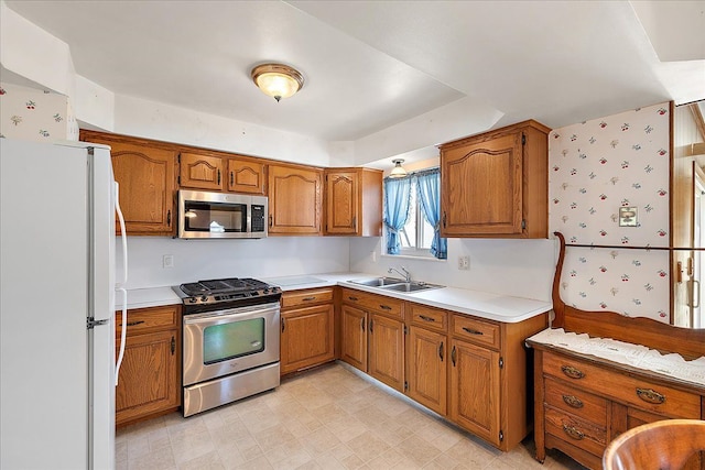 14953 Colpaert Dr, Warren, MI 48088 - kitchen with brown cabinets, appliances with stainless steel finishes, a sink, and light countertops