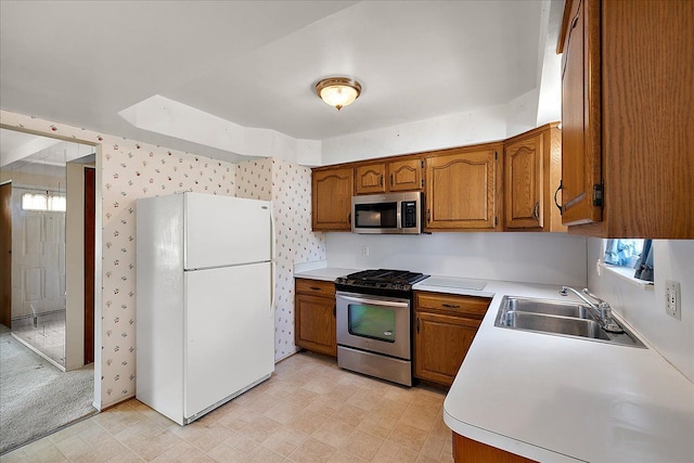14953 Colpaert Dr, Warren, MI 48088 - kitchen featuring light floors, light countertops, brown cabinets, a sink, and stainless steel appliances