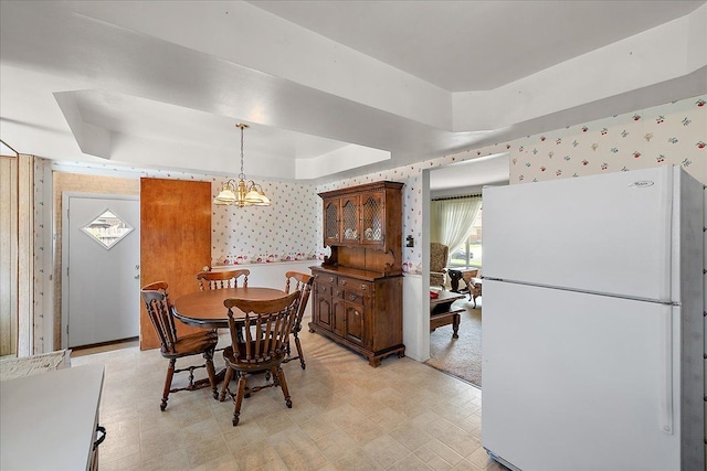 14953 Colpaert Dr, Warren, MI 48088 - dining area with a tray ceiling, a chandelier, wallpapered walls, and light floors