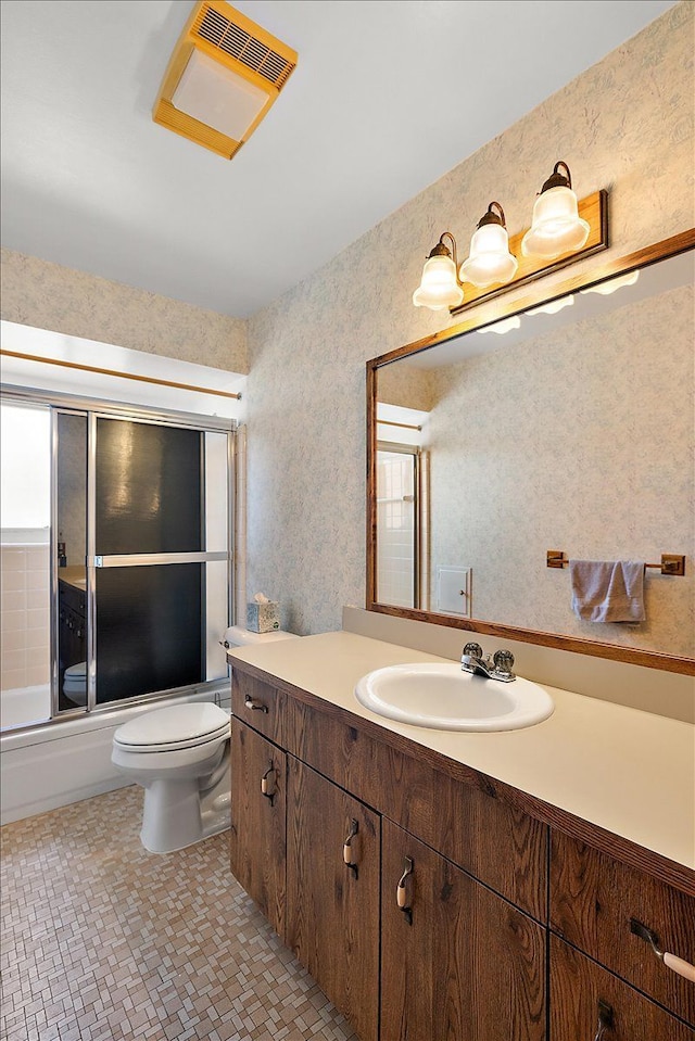 14953 Colpaert Dr, Warren, MI 48088 - full bathroom featuring vanity, wallpapered walls, combined bath / shower with glass door, and toilet