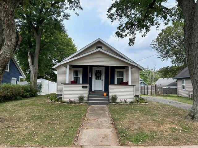 21 River St, Niles, MI 49120 - bungalow with fence, a porch, and a front yard