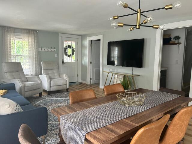 21 River St, Niles, MI 49120 - living area with plenty of natural light, baseboards, wood finished floors, and an inviting chandelier