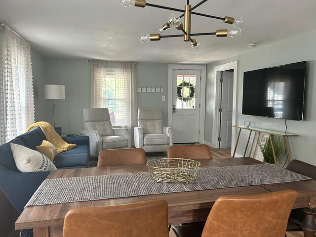 21 River St, Niles, MI 49120 - living area featuring baseboards, wood finished floors, and an inviting chandelier