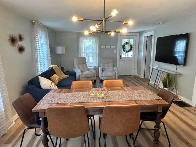 21 River St, Niles, MI 49120 - dining room with baseboards, wood finished floors, and a notable chandelier