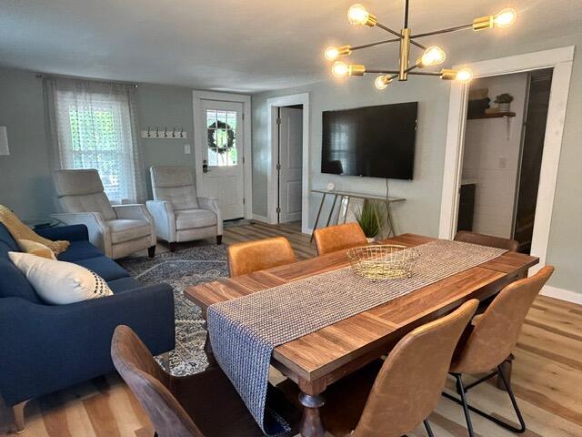 21 River St, Niles, MI 49120 - dining space with baseboards, a chandelier, and light wood-style floors