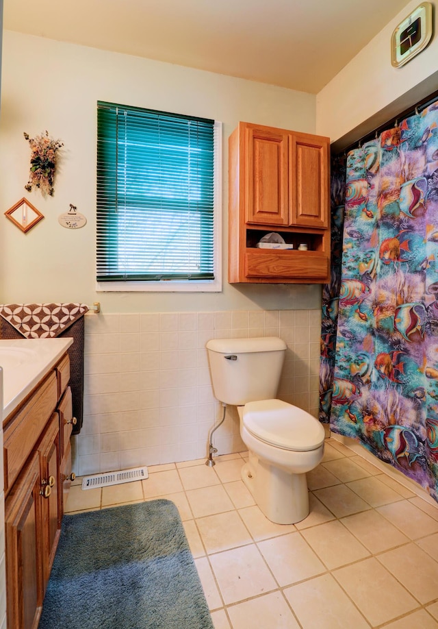 2103 Island Dr, Wayland, MI 49348 - full bath featuring toilet, tile patterned floors, tile walls, and vanity