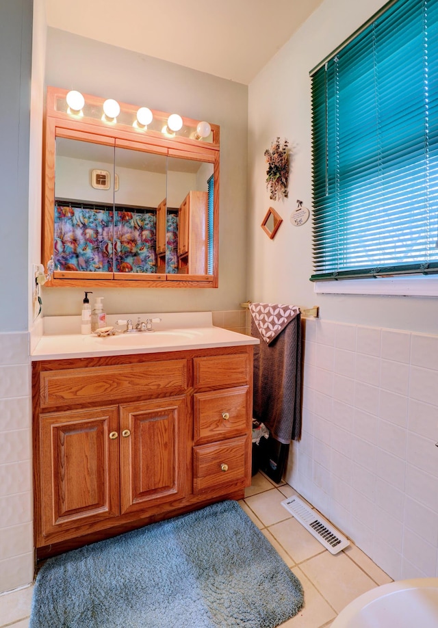 2103 Island Dr, Wayland, MI 49348 - full bath with visible vents, tile patterned floors, tile walls, and vanity