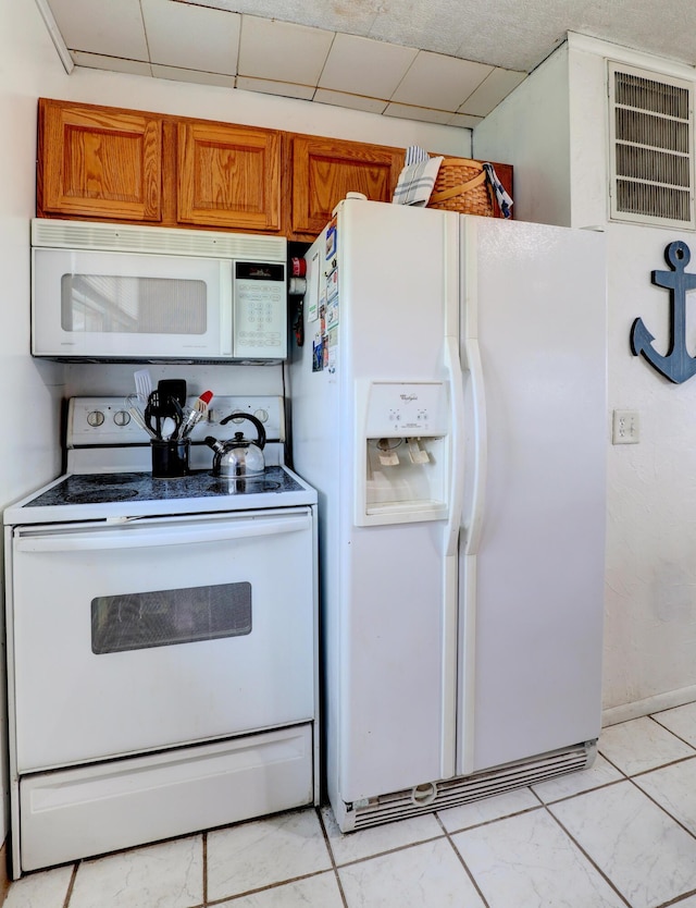 2103 Island Dr, Wayland, MI 49348 - kitchen featuring visible vents, brown cabinets, and white appliances