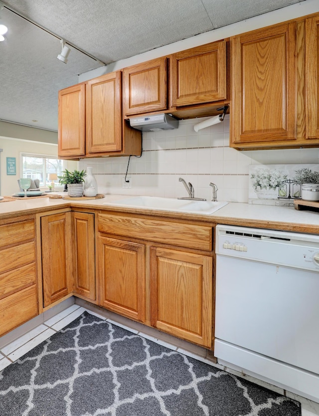 2103 Island Dr, Wayland, MI 49348 - kitchen with track lighting, a sink, dishwasher, a textured ceiling, and tasteful backsplash