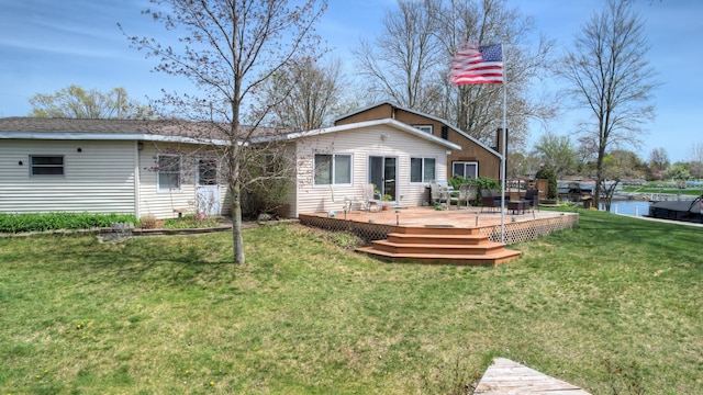 2103 Island Dr, Wayland, MI 49348 - rear view of property featuring a lawn and a deck with water view