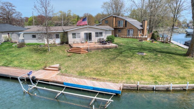 2103 Island Dr, Wayland, MI 49348 - back of house featuring a lawn, a chimney, and a deck with water view