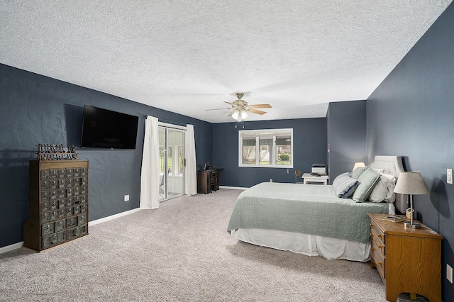carpeted bedroom featuring a textured ceiling, a ceiling fan, and baseboards