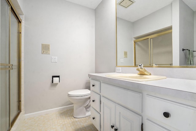 bathroom with a shower stall, baseboards, toilet, and tile patterned floors
