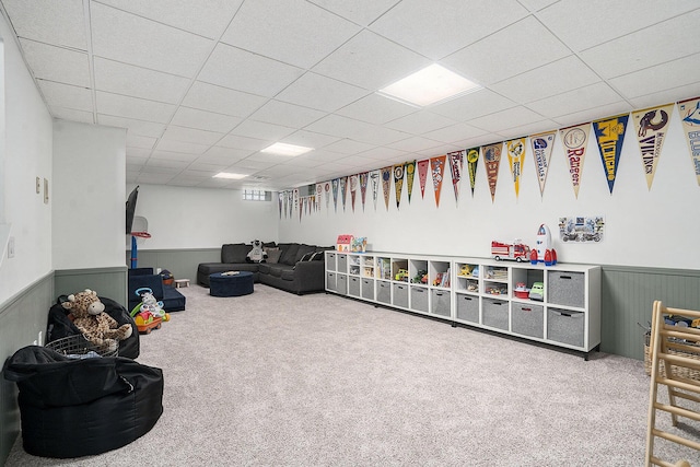 game room with wainscoting, a paneled ceiling, and carpet