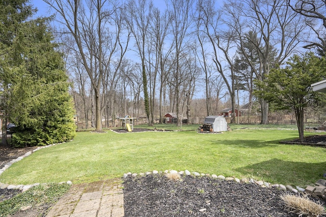 view of yard with an outbuilding and a storage shed