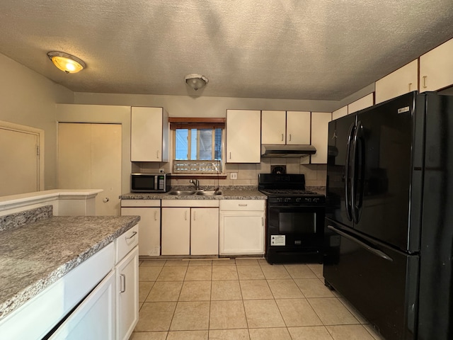 kitchen with under cabinet range hood, white cabinetry, a sink, and black appliances