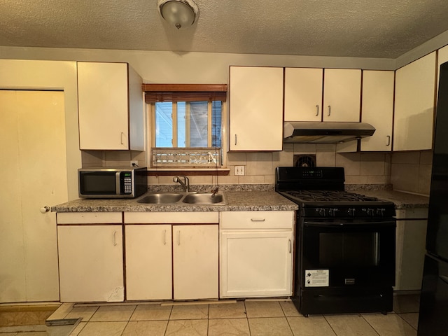 kitchen with a sink, white cabinetry, under cabinet range hood, and black appliances