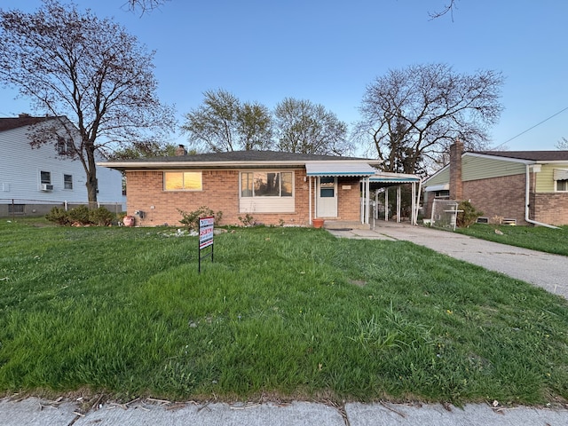 view of front facade featuring fence, a front lawn, brick siding, a chimney, and concrete driveway