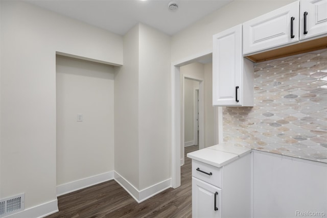 12061 Nashville St, Detroit, MI 48205 - kitchen with dark wood finished floors, white cabinetry, baseboards, and tasteful backsplash