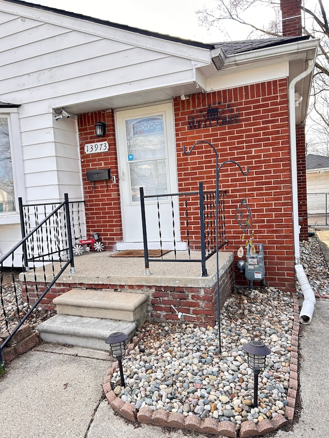 13973 Brady, Redford, MI 48239 - view of exterior entry with brick siding and a chimney