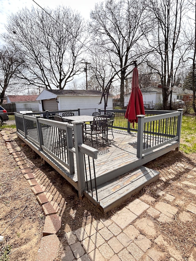 13973 Brady, Redford, MI 48239 - wooden terrace with outdoor dining space, an outbuilding, a garage, and fence