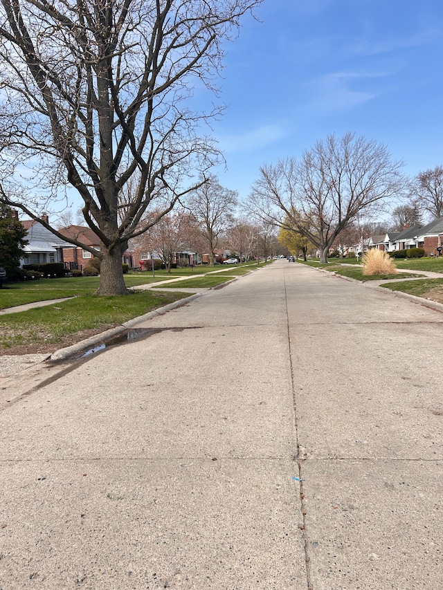 13973 Brady, Redford, MI 48239 - view of concrete street with sidewalks, a residential view, and curbs