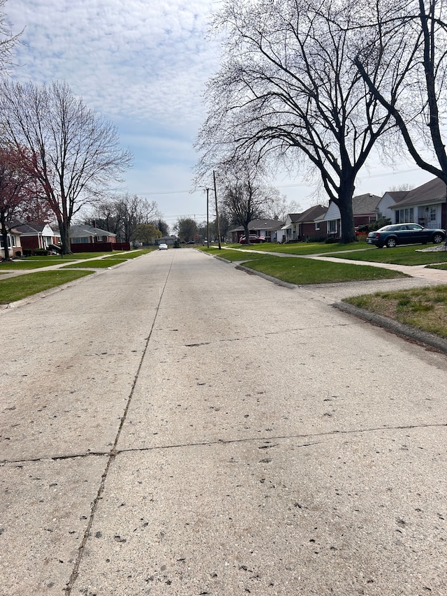 13973 Brady, Redford, MI 48239 - view of concrete road featuring a residential view, sidewalks, and curbs
