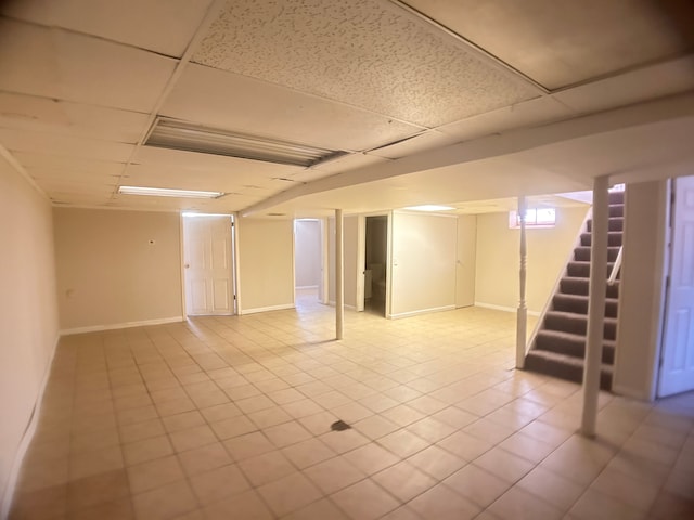 13973 Brady, Redford, MI 48239 - finished basement with a paneled ceiling, stairway, tile patterned floors, and baseboards