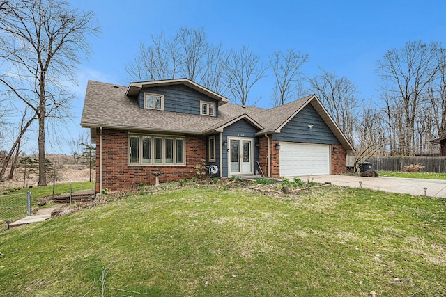 2569 Ridgewood Trl, Berrien Springs, MI 49103 - view of front of house featuring fence, a front lawn, concrete driveway, brick siding, and a garage
