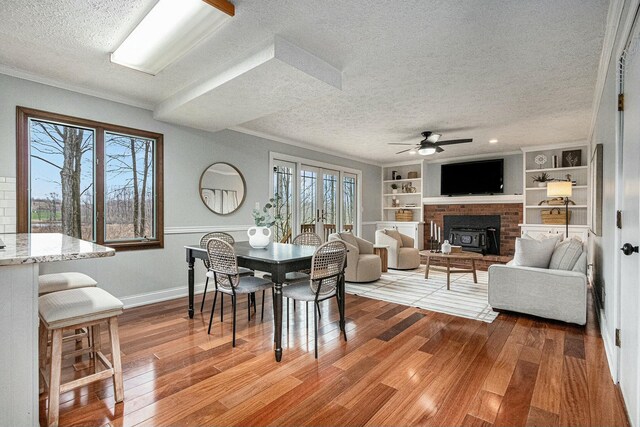 2569 Ridgewood Trl, Berrien Springs, MI 49103 - dining room with wood finished floors, a textured ceiling, built in shelves, ceiling fan, and baseboards