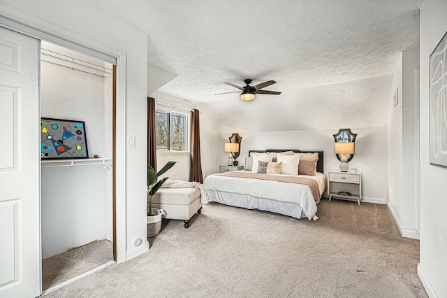 2569 Ridgewood Trl, Berrien Springs, MI 49103 - carpeted bedroom with lofted ceiling, a ceiling fan, baseboards, and a textured ceiling